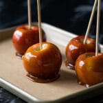 Healthy low carb caramel apples on a gold baking tray