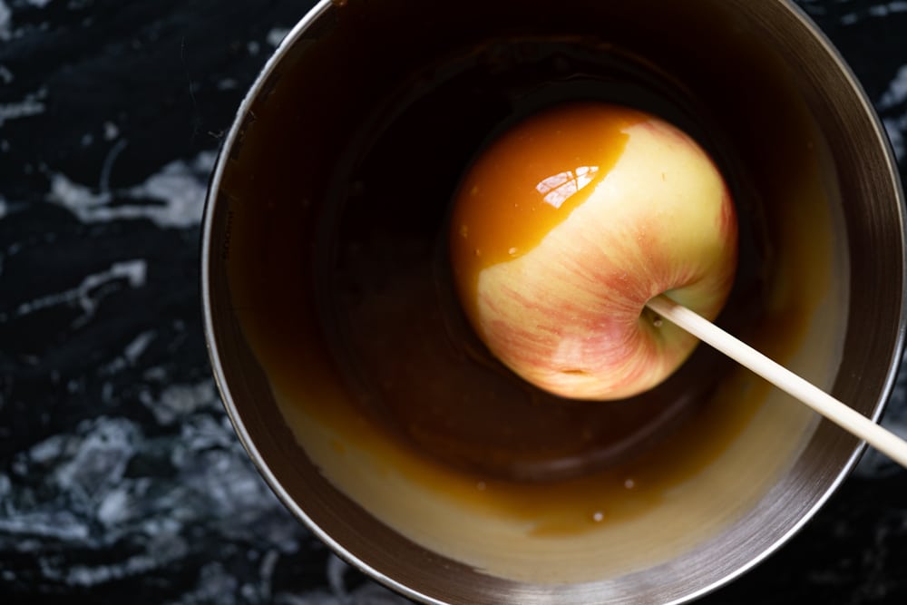 Dipping an apple into keto caramel