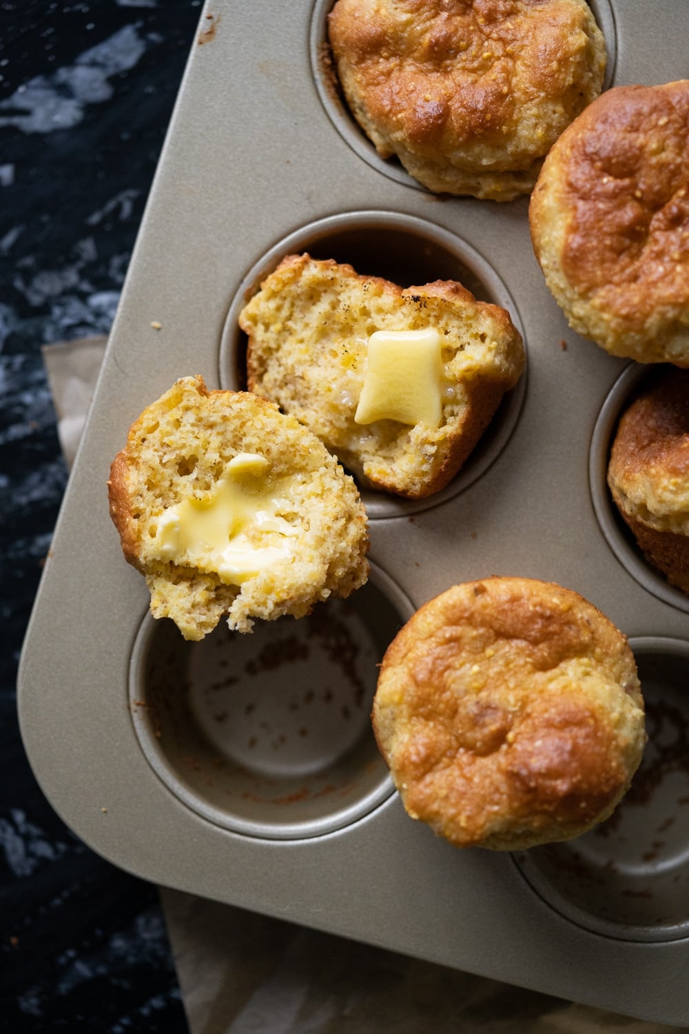 Freshly baked low carb cornbread with cornmeal and a pat of butter melting through