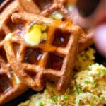 Gluten free and keto sourdough waffles with butter, sugar free syrup and a side of scrambled eggs