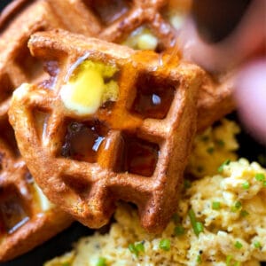 Gluten free and keto sourdough waffles with butter, sugar free syrup and a side of scrambled eggs