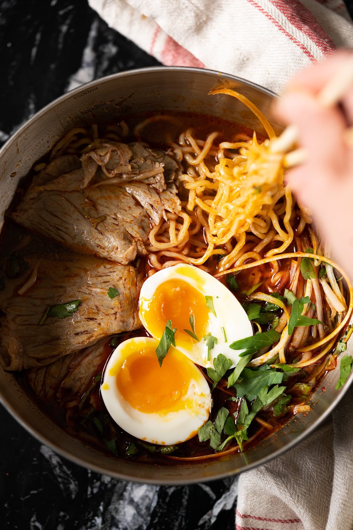 Taking keto shirataki noodles in a ramen soup with chop sticks