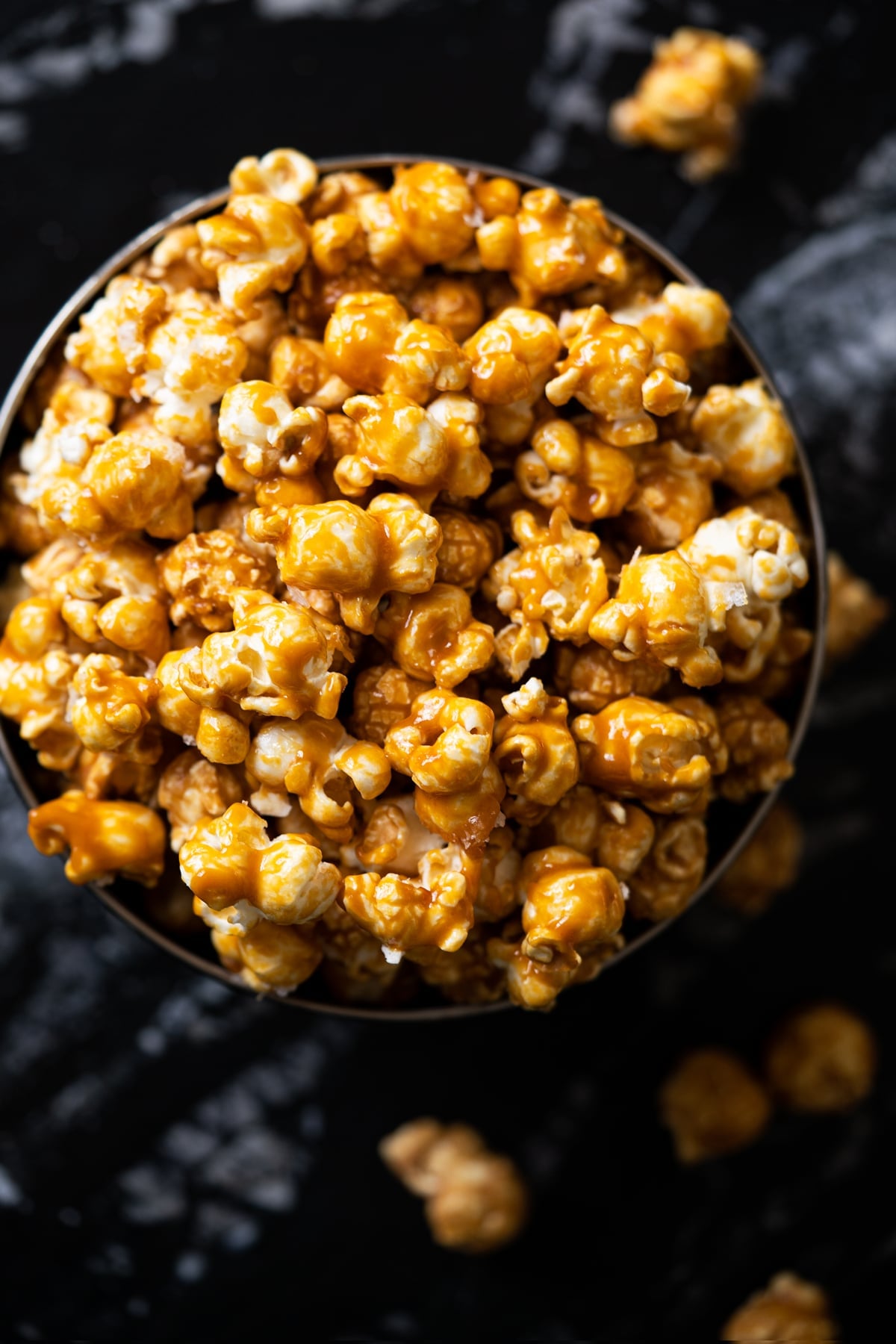 Overhead shot of low carb & sugar free caramel popcorn in a black bowl