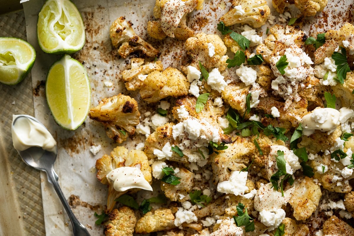 Keto Mexican street corn (i.e. esquites) with cauliflower on a baking tray