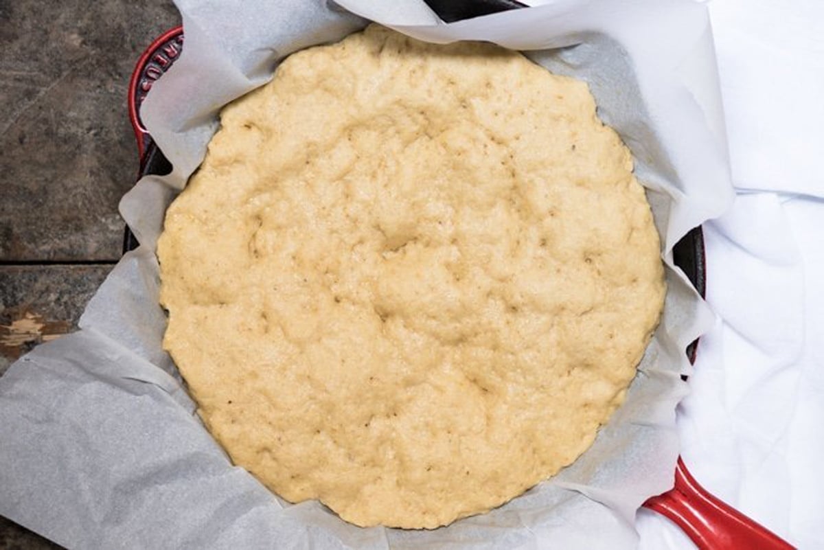Unbaked keto pizza crust with yeast after rise