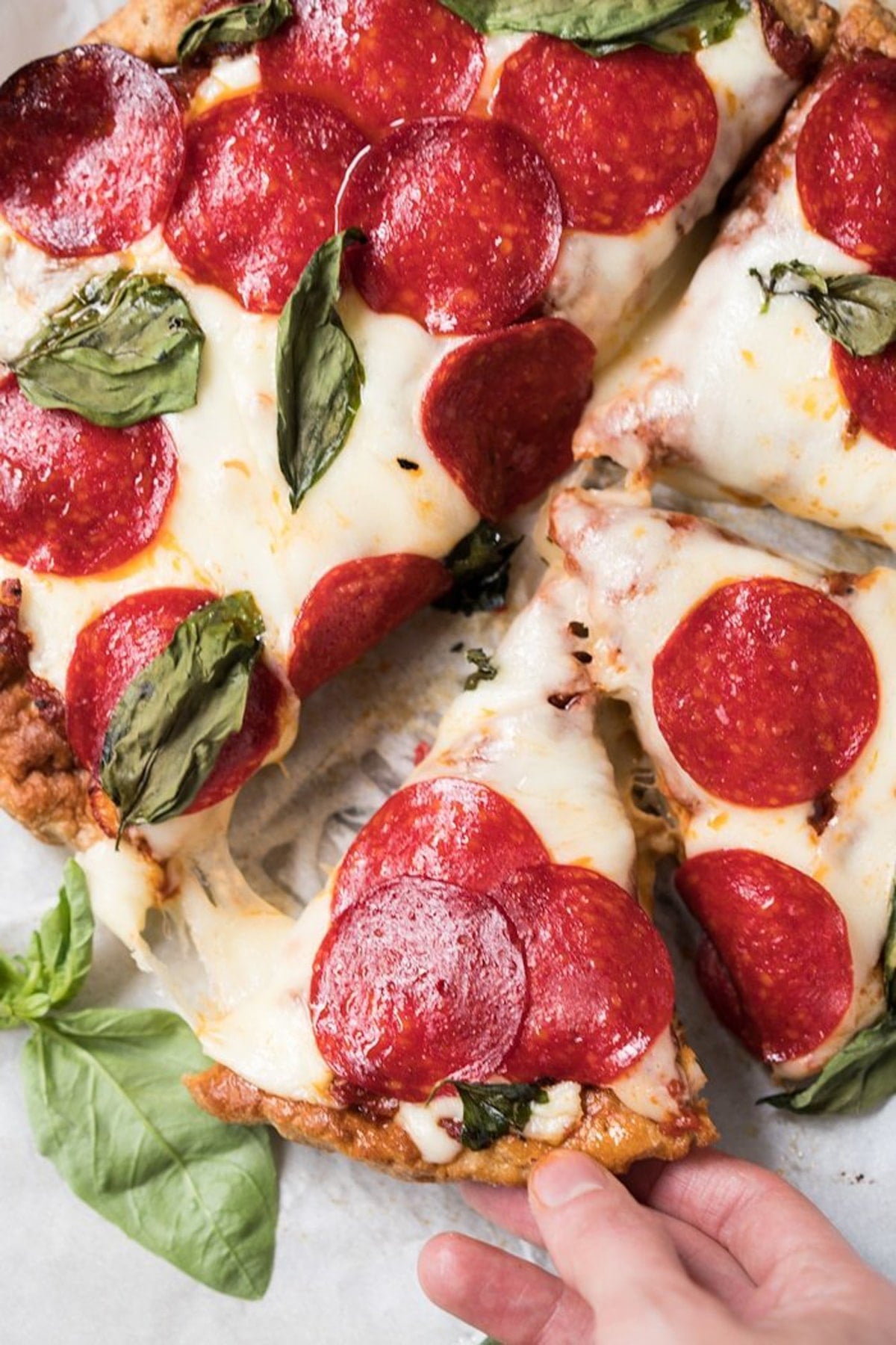 Taking a slice of the keto pizza