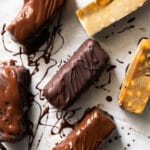 Healthy homemade keto snickers bars on a baking tray with caramel and chocolate
