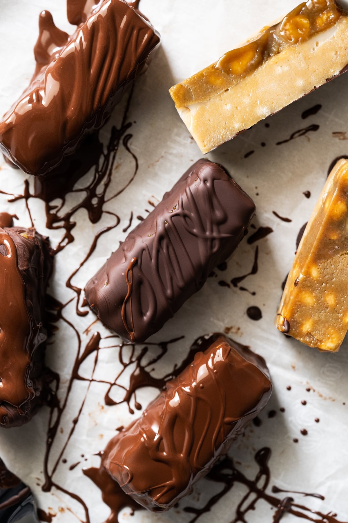 Healthy homemade keto snickers bars on a baking tray with caramel and chocolate