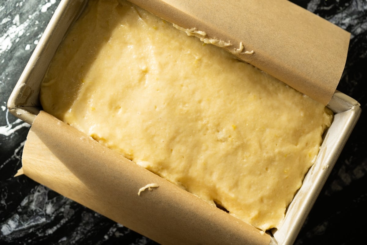 Smoothing out the top of the gluten free lemon pound cake batter before baking with wet fingertips