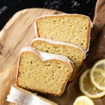 Three slices of iced keto lemon pound cake on a wooden board