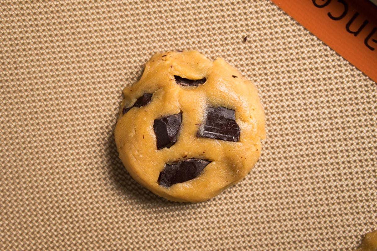 Unbaked flourless cookie dough on a baking mat