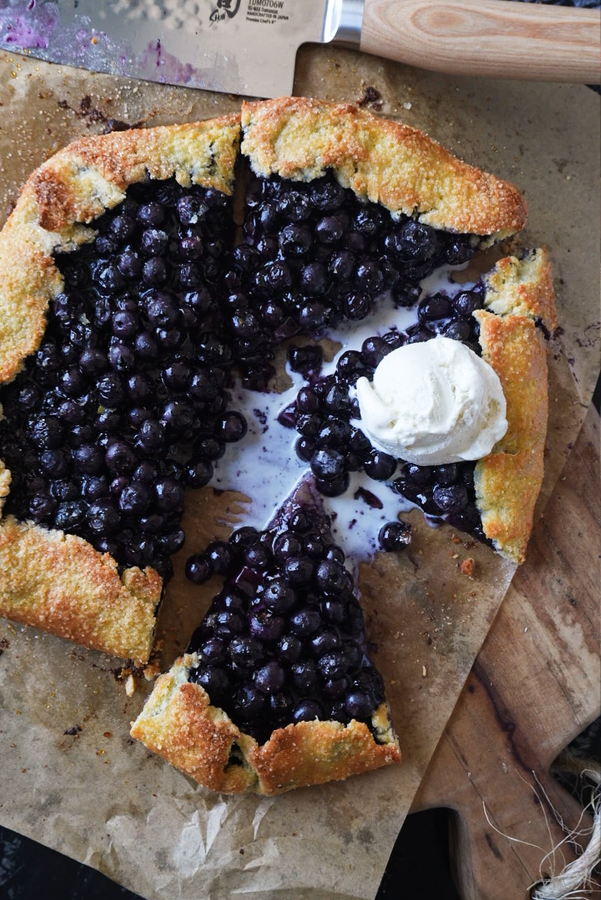 A keto blueberry galette with a scoop of vanilla ice cream