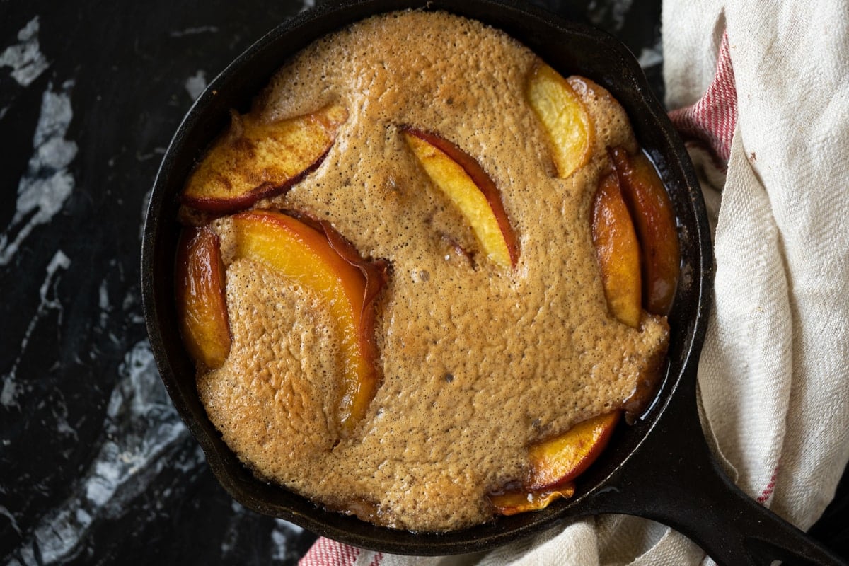 Freshly baked keto peach cobbler in a skiller