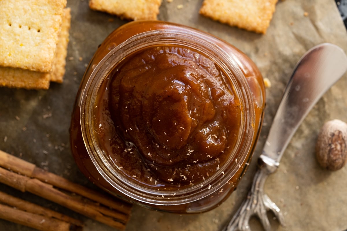 Homemade keto pumpkin butter in a mason jar served with cornbread crackers