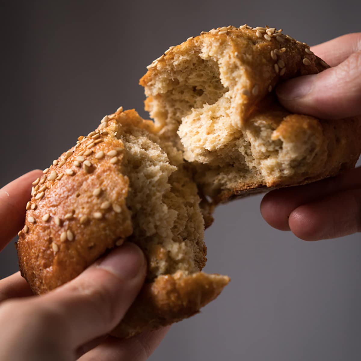 Tearing a keto wholewheat bun (with yeast!) to show it's fluffy and soft texture