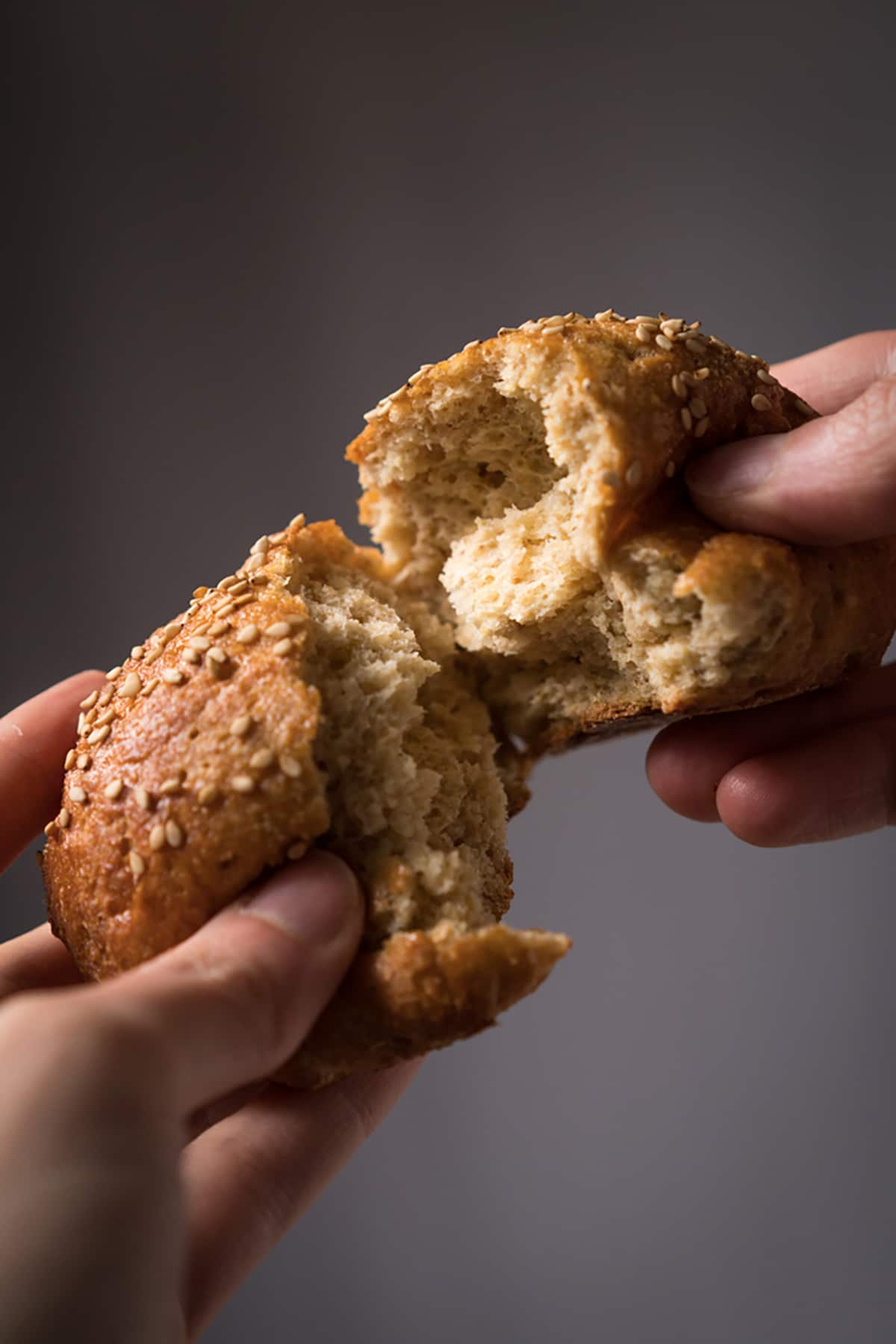 Tearing a keto wholewheat bun (with yeast!) to show it's fluffy and soft texture