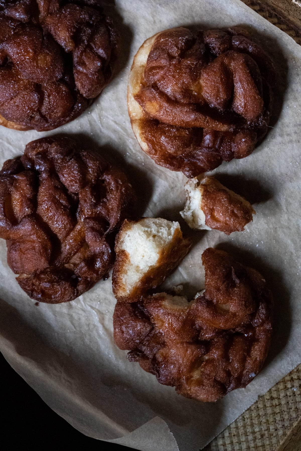 A baked keto apple fritter torn in half to show the fluffy texture