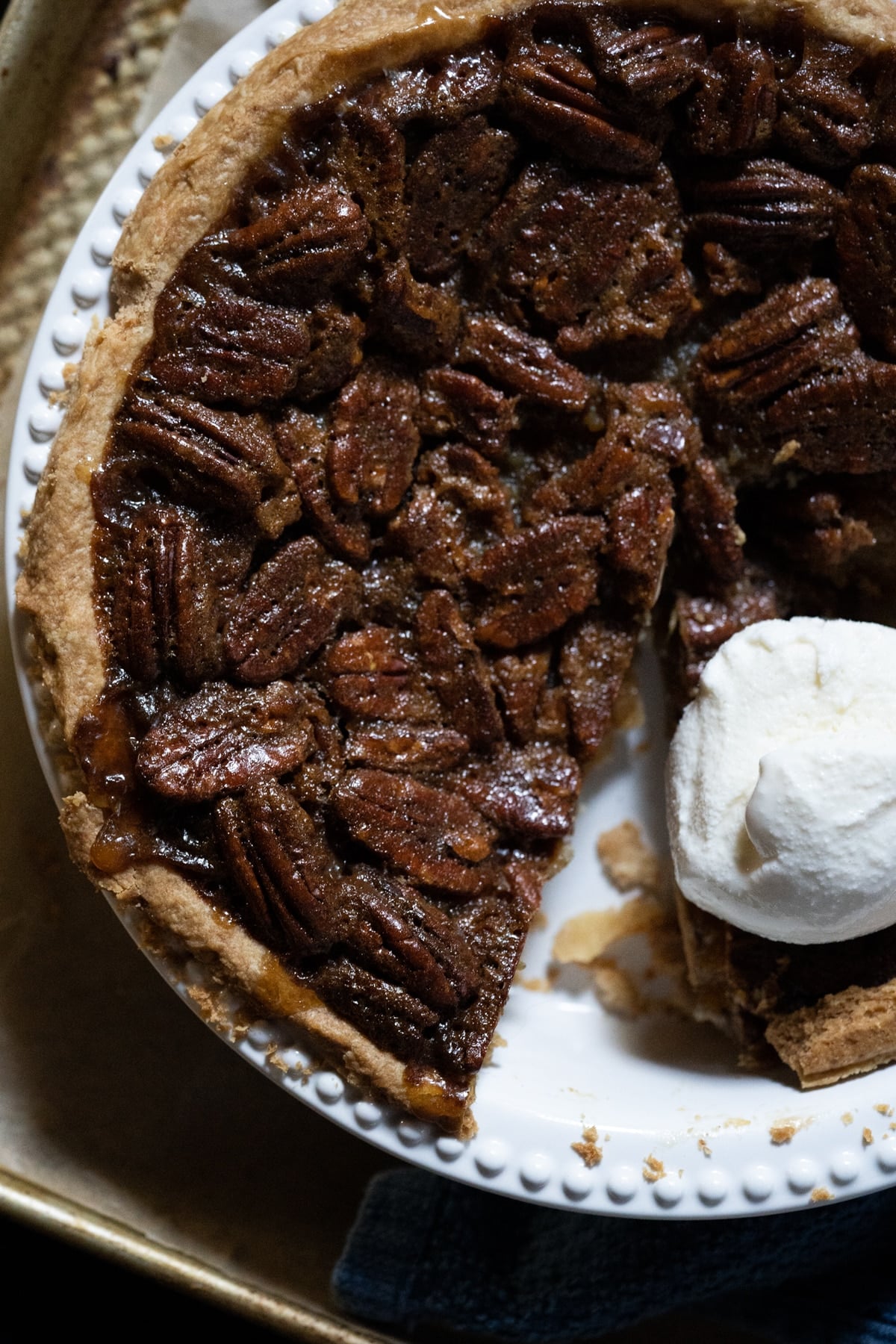 Keto pecan pie with a scoop of vanilla ice cream