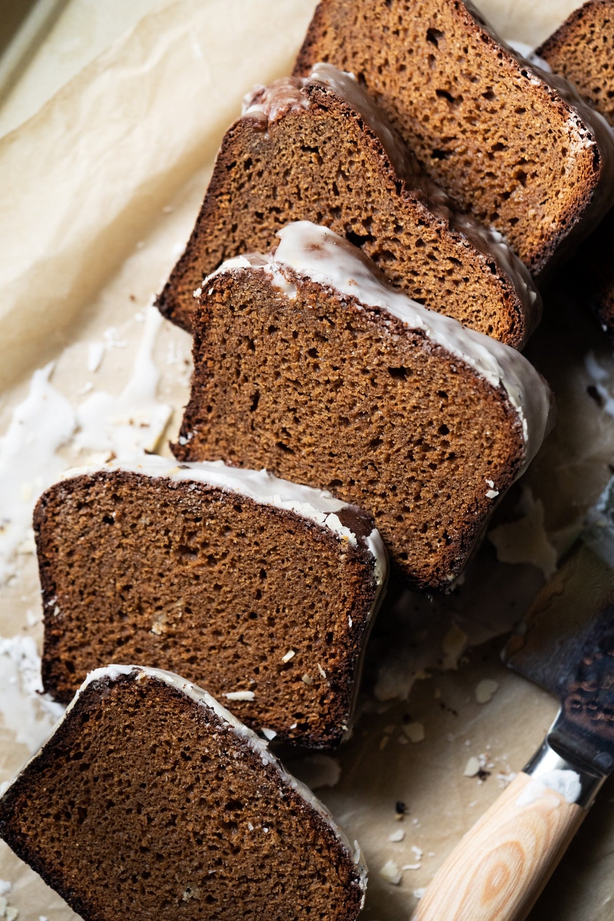 Sliced and freshly glazed low carb gingerbread loaf showing the fluffy texture