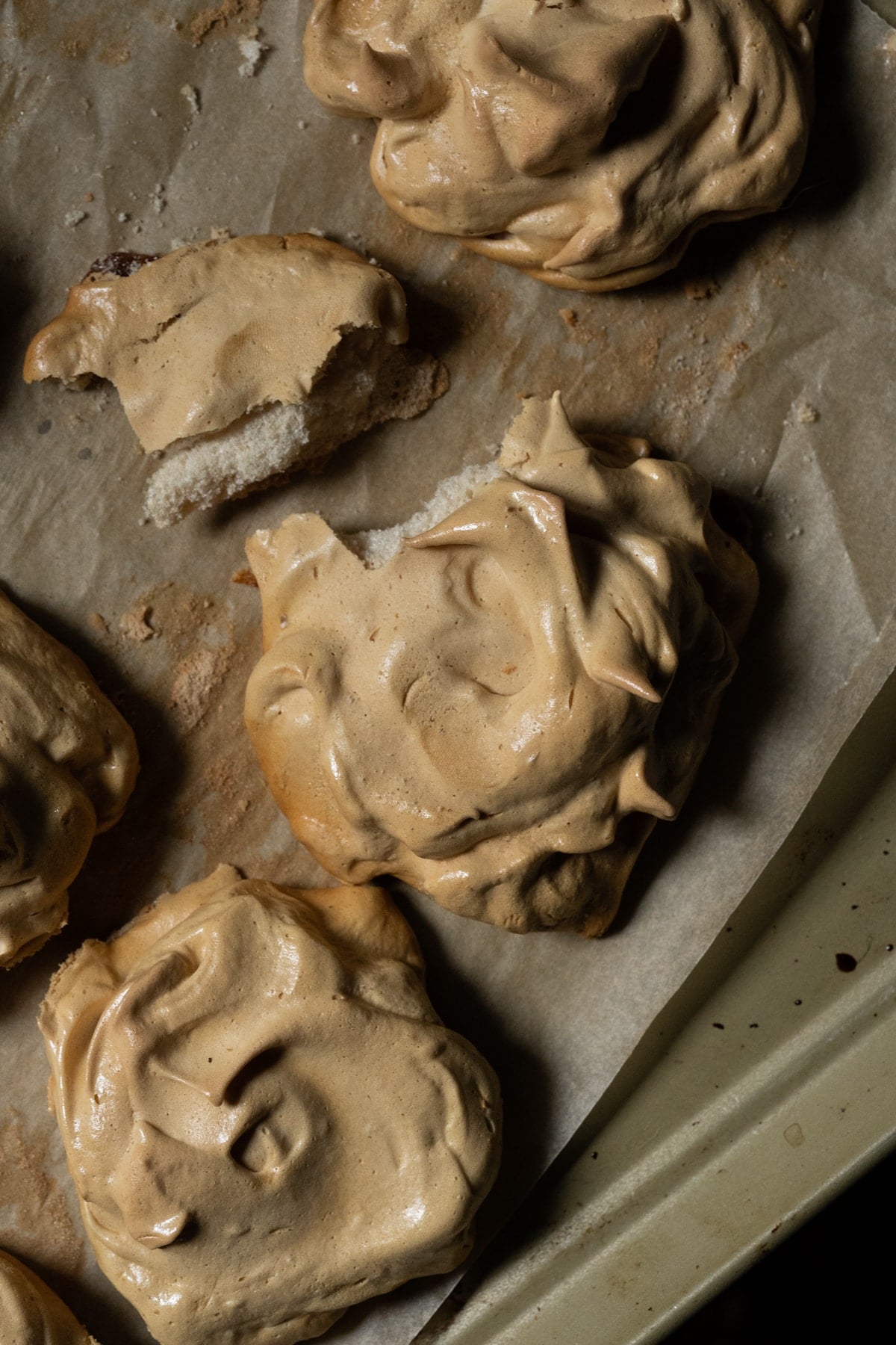 Breaking a maple meringue in half to show the crisp exterior and chewy center