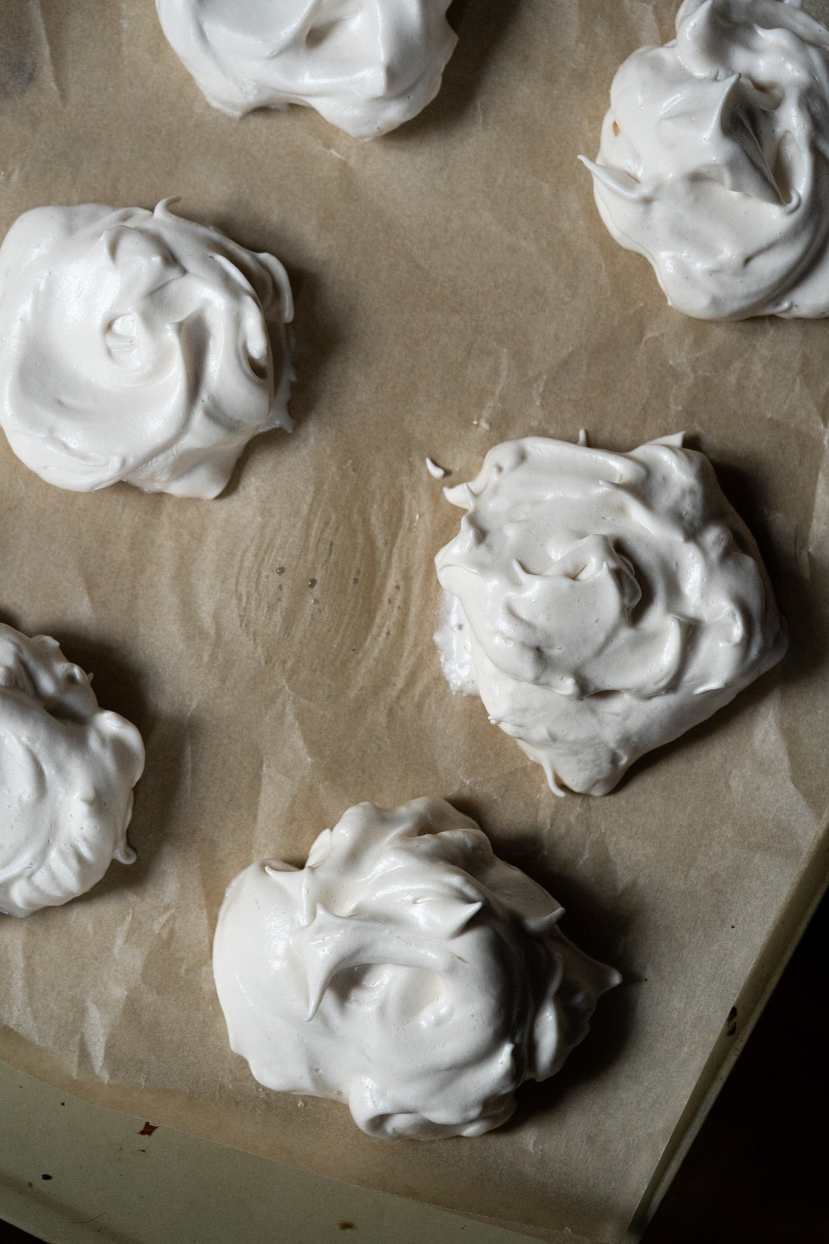 Unbaked maple syrup meringue fluff on a baking tray with parchment paper
