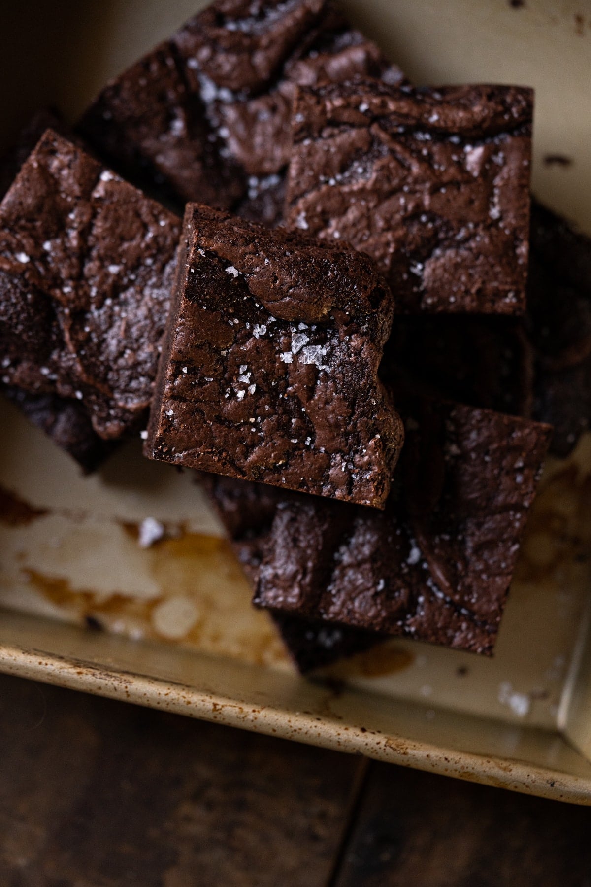 Closeup freshly cut almond flour brownie stack showing their shiny tops