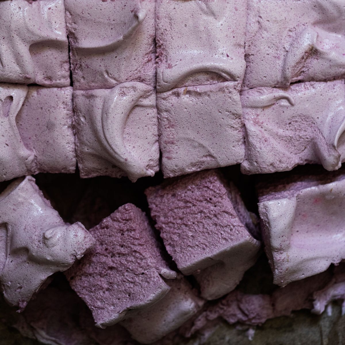 Freshly sliced maple syrup marshmallows with grape juice showing their fluffy texture and purple hue