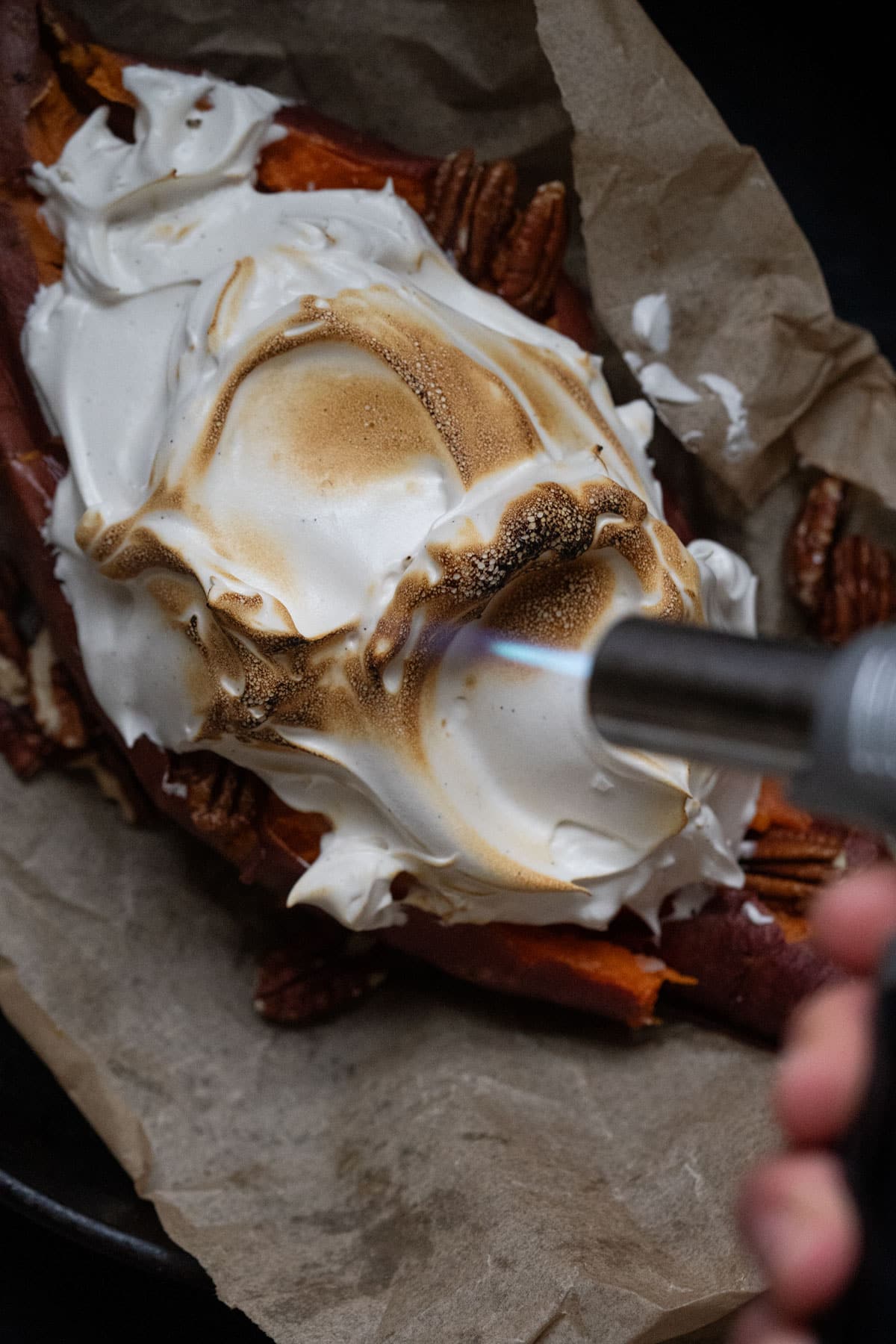 Charring homemade marshmallow fluff with a torch