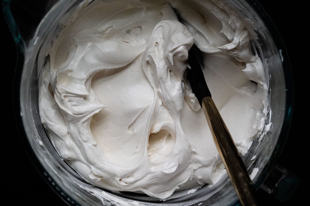 Freshly whipped homemade honey marshmallow fluff in the bowl of a stand mixer