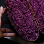 Purple sweet potato sourdough halved showing the bright colored crumb