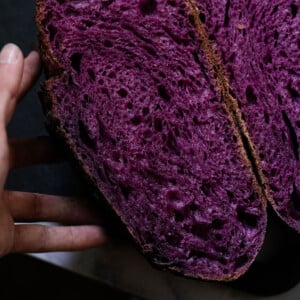 Purple sweet potato sourdough halved showing the bright colored crumb