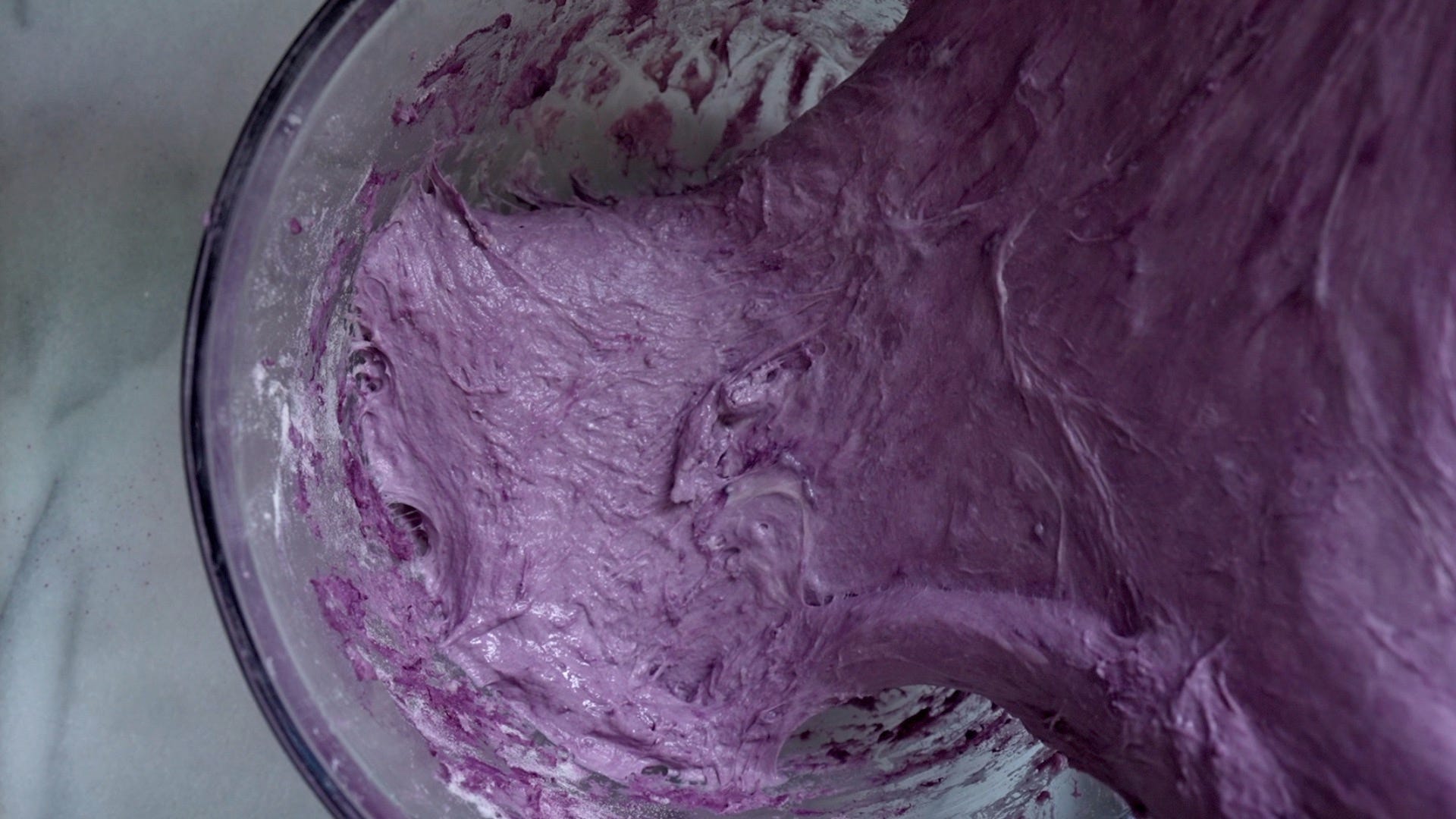 Doing stretch and folds with the sourdough purple sweet potato dough