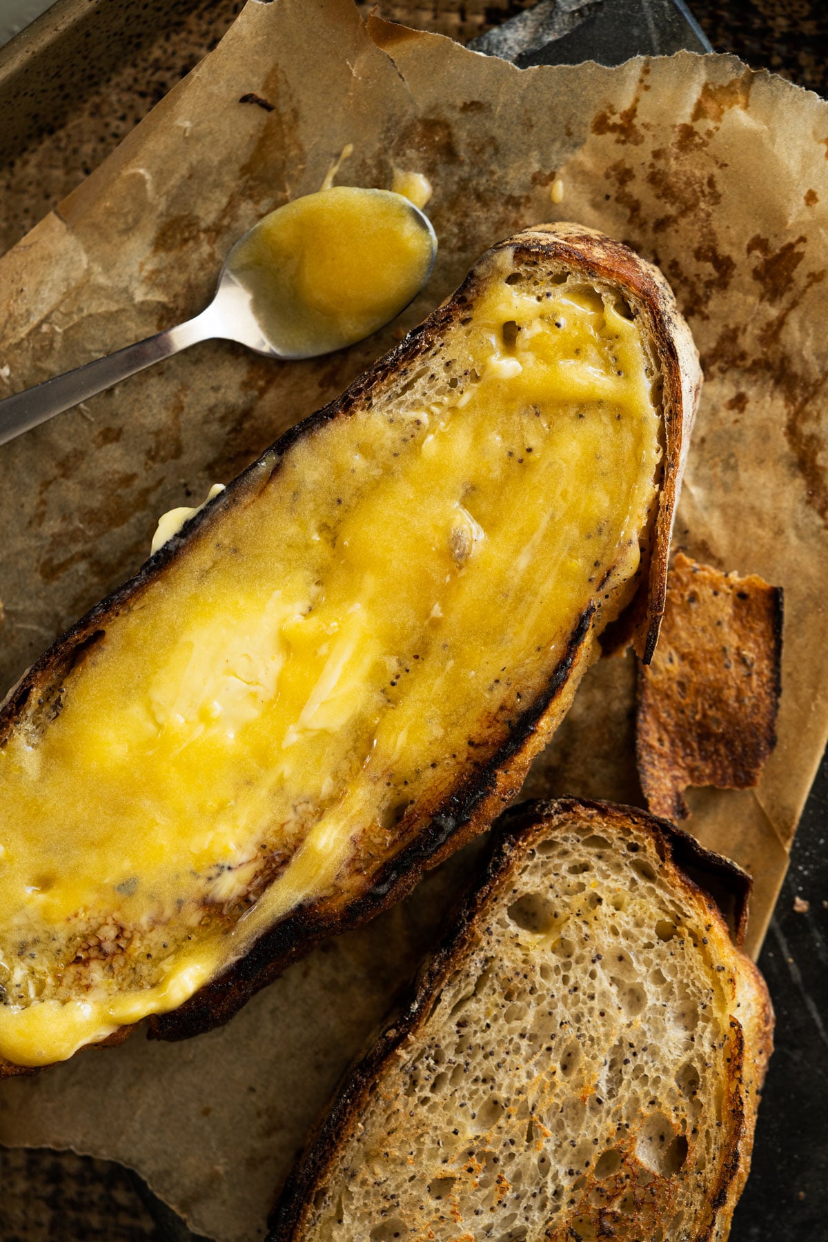 Lemon curd smothered on a slice of poppy seed sourdough